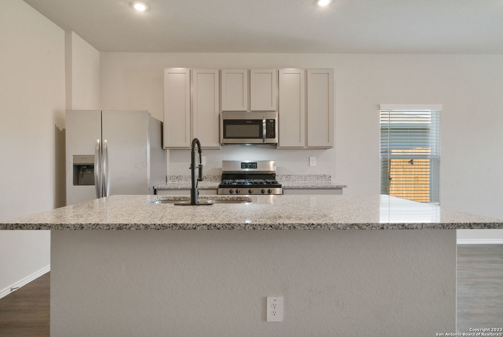 10107 Abrams View Converse, TX 78109 - Photo 11 of 25 a kitchen with granite countertop a refrigerator a stove a sink and a granite counter tops