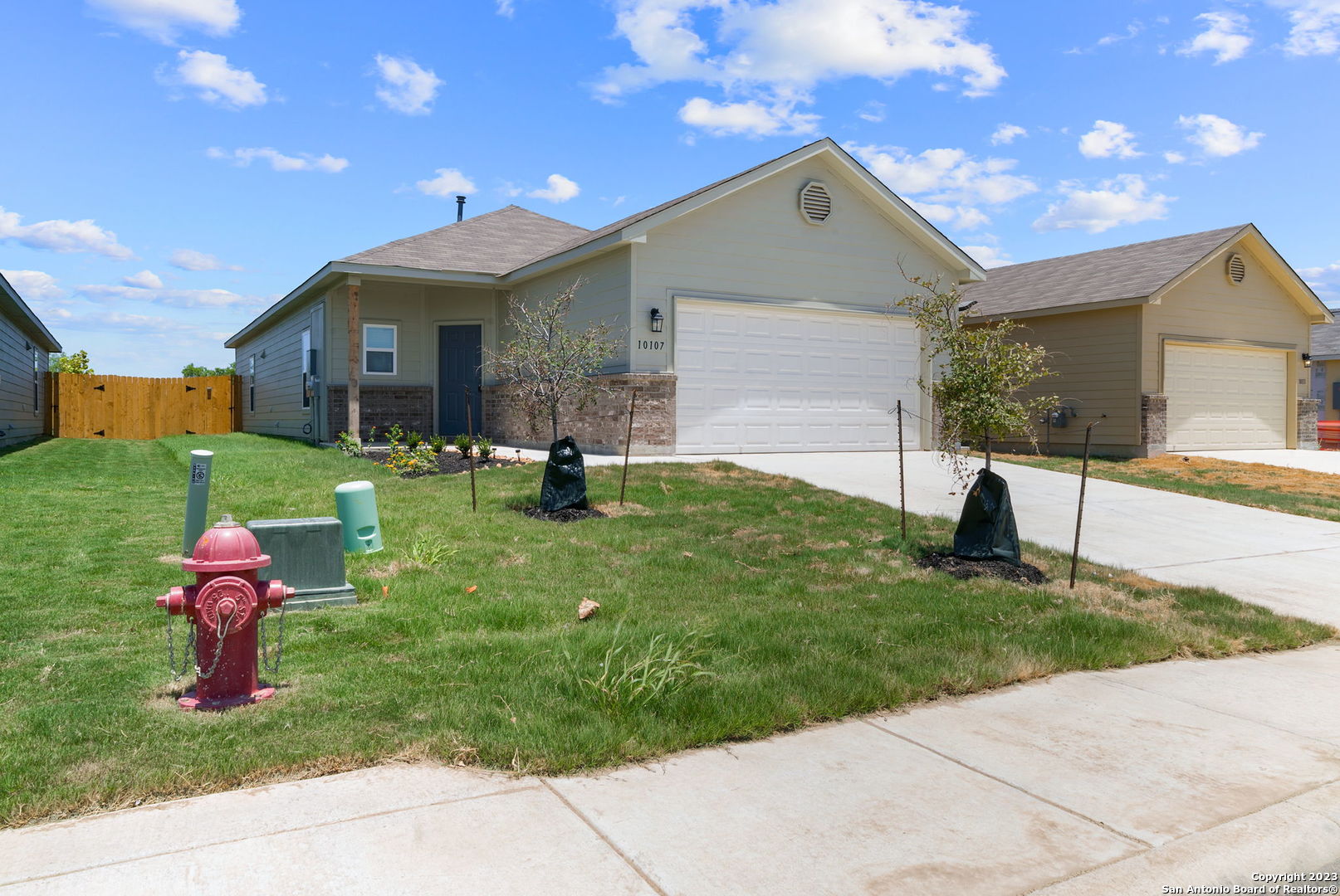 10107 Abrams View Converse, TX 78109 - Photo 2 of 25 a front view of a house with a yard and garage