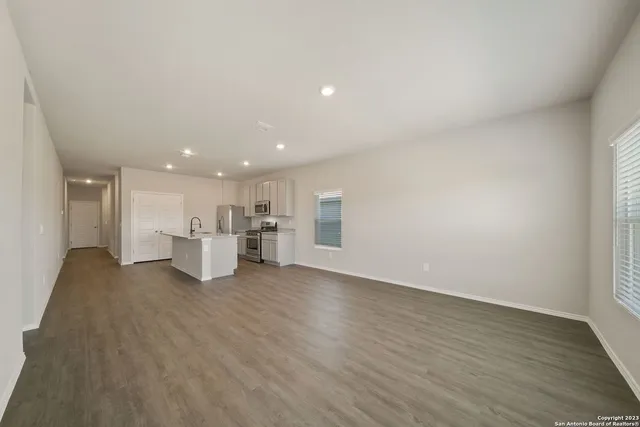 a view of a kitchen with a sink and a refrigerator