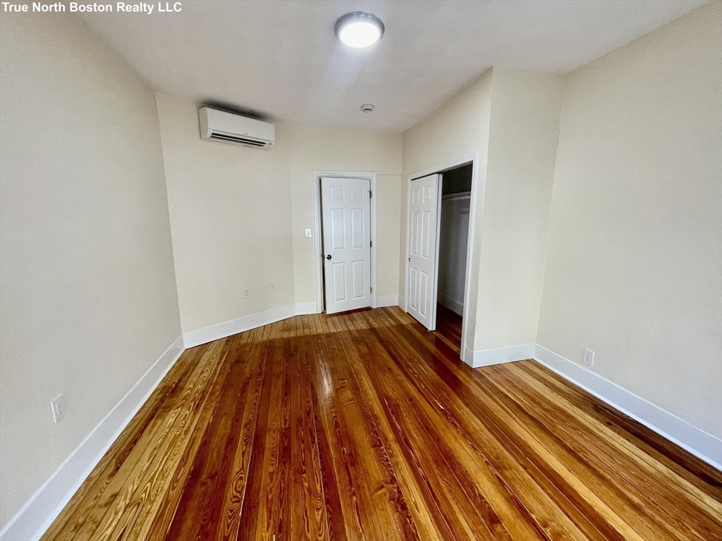 207 Princeton Street, Unit 1 Boston, MA 02128 - Photo 9 of 15 a view of a room with wooden floor and bathroom