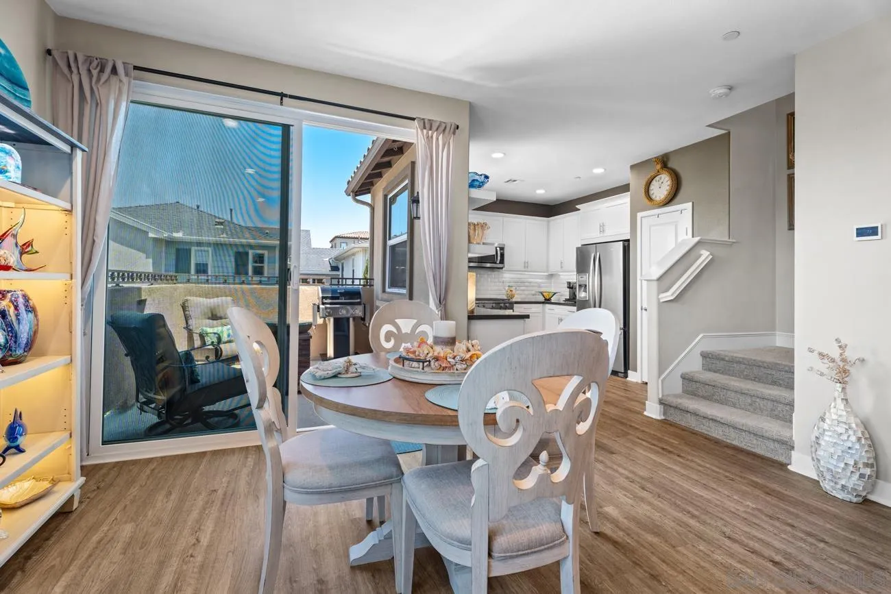 4326 Star Path Way, Unit 1 Oceanside, CA 92056 - Photo 16 of 46 a dining room with furniture entryway and wooden floor