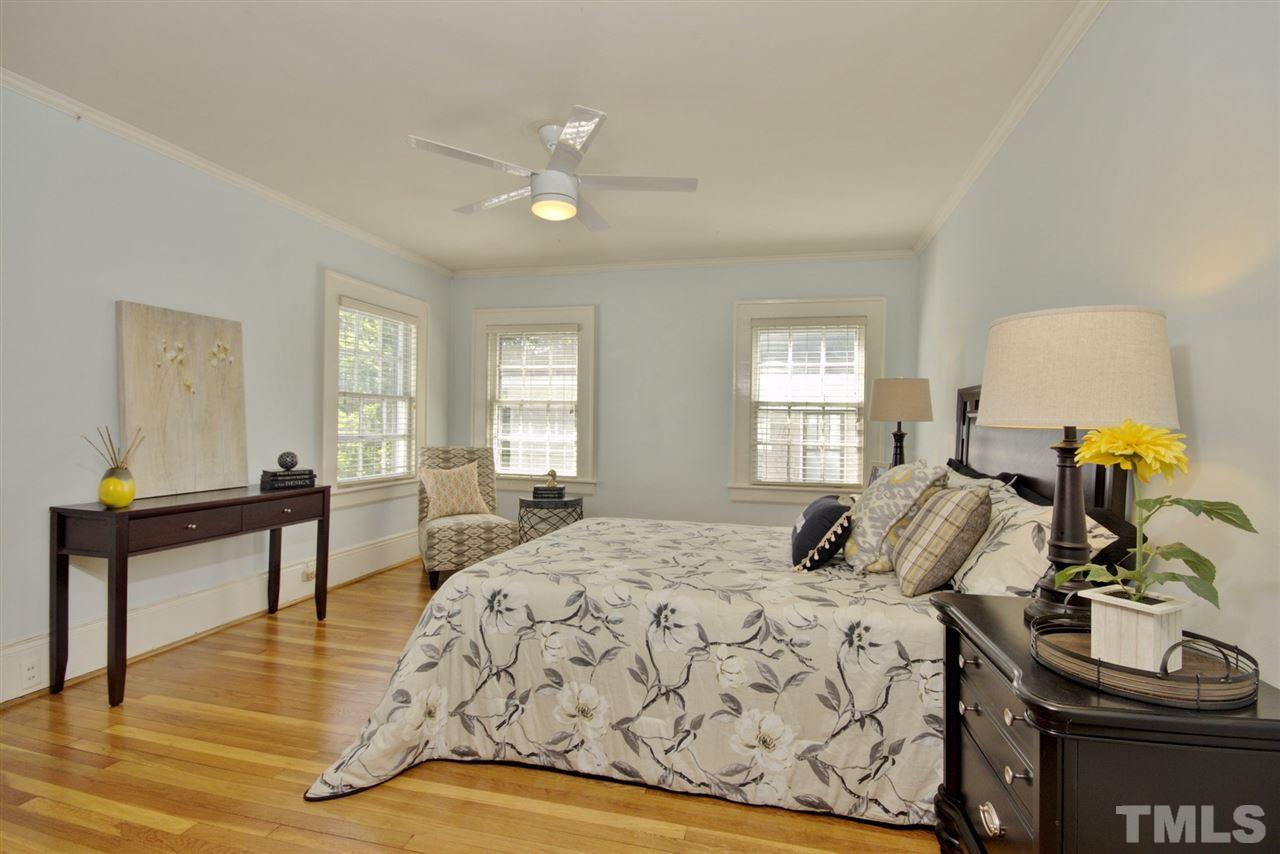 2302 Fairview Road Raleigh, NC 27608 - Photo 12 of 25 a bedroom with a bed and wooden floor