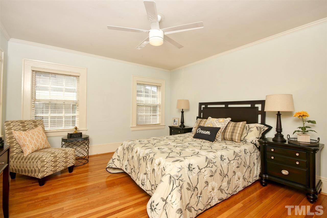 2302 Fairview Road Raleigh, NC 27608 - Photo 13 of 25 a bedroom with a bed and wooden floor