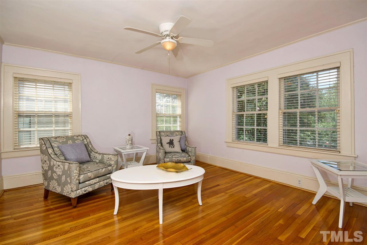 2302 Fairview Road Raleigh, NC 27608 - Photo 14 of 25 a living room with furniture a table and chair with wooden floor