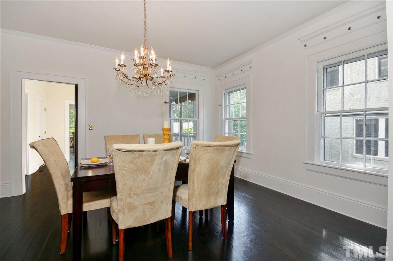 2302 Fairview Road Raleigh, NC 27608 - Photo 7 of 25 a view of a dining room with furniture a chandelier and wooden floor