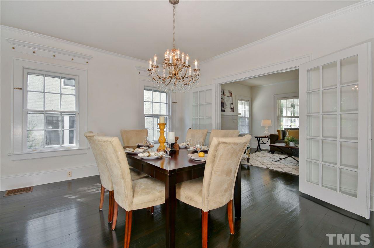 2302 Fairview Road Raleigh, NC 27608 - Photo 8 of 25 a view of a dining room with furniture wooden floor and chandelier