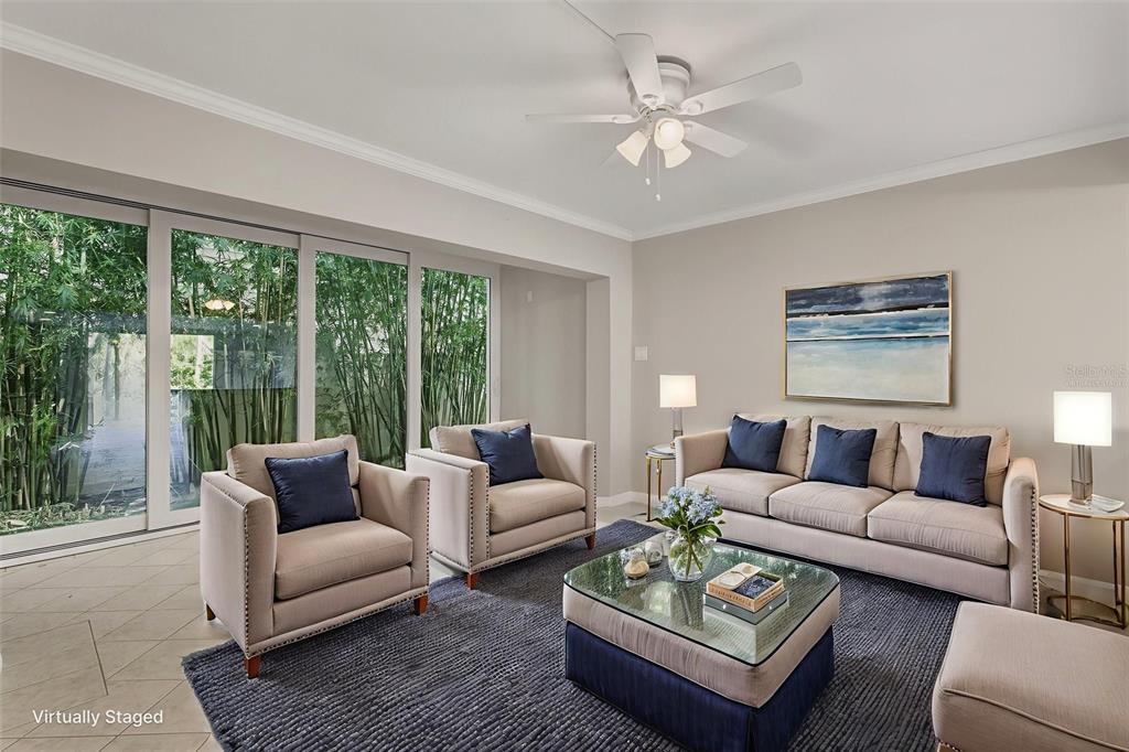 5055 North Beach Road, Unit 106 Englewood, FL 34223 - Photo 13 of 34 a living room with furniture a large window and a rug