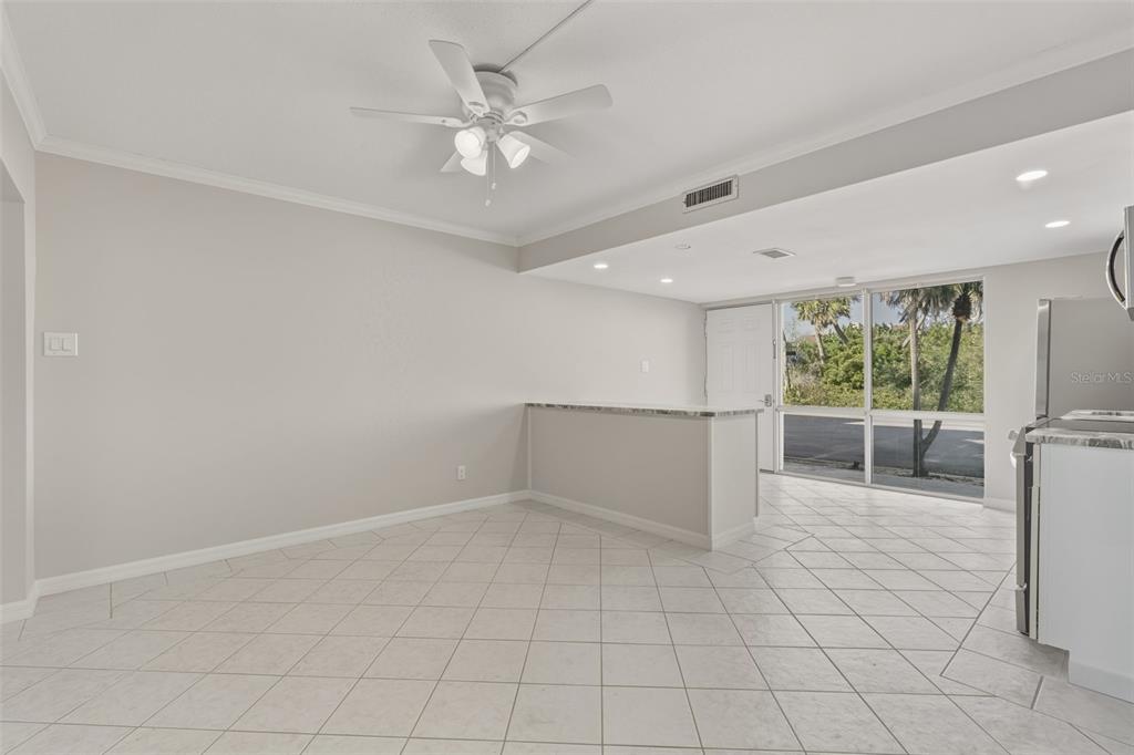 5055 North Beach Road, Unit 106 Englewood, FL 34223 - Photo 14 of 34 an empty room with windows and fan
