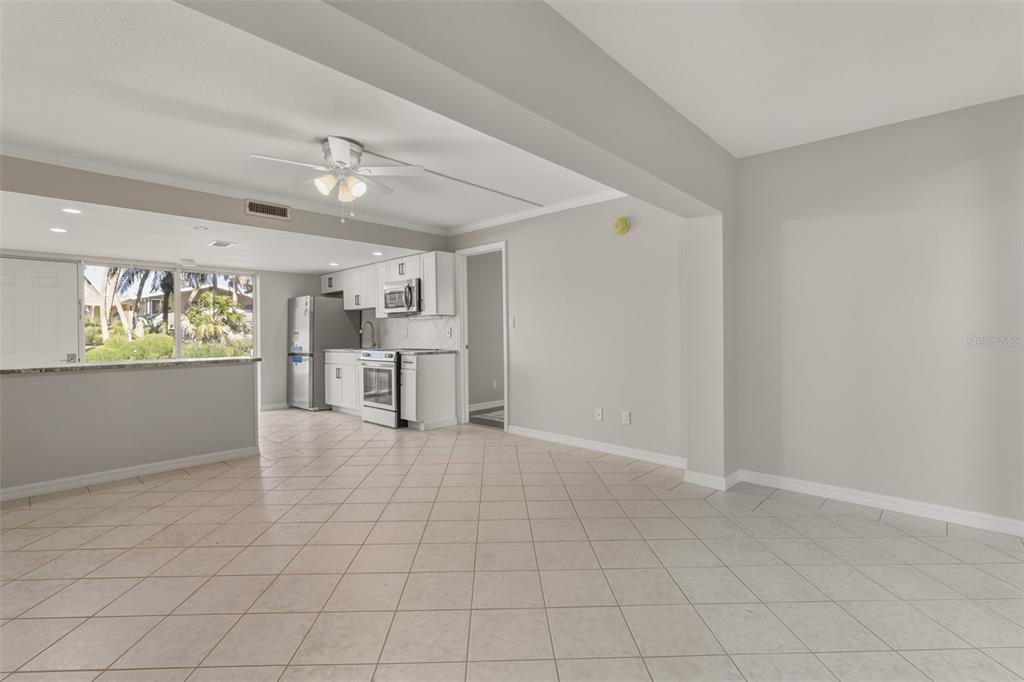 5055 North Beach Road, Unit 106 Englewood, FL 34223 - Photo 15 of 34 a view of a kitchen with furniture and an empty room