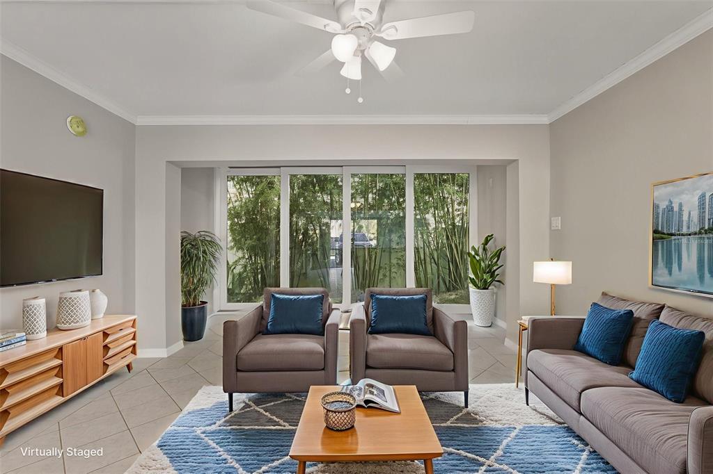 5055 North Beach Road, Unit 106 Englewood, FL 34223 - Photo 16 of 34 a living room with furniture and a flat screen tv
