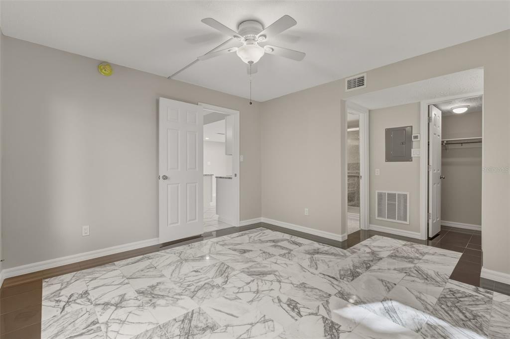 5055 North Beach Road, Unit 106 Englewood, FL 34223 - Photo 17 of 34 a view of a big room with closet and a chandelier fan