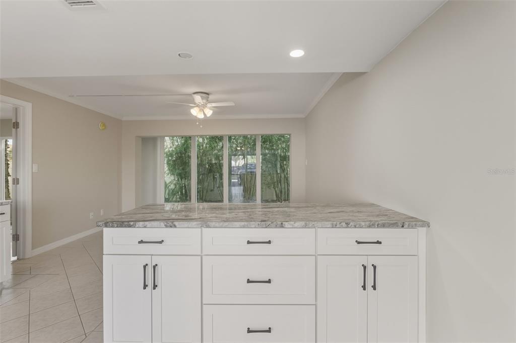 5055 North Beach Road, Unit 106 Englewood, FL 34223 - Photo 5 of 34 a room with granite countertop cabinets and window