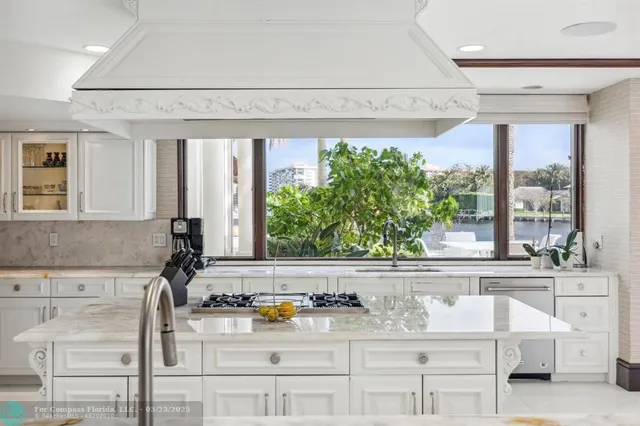 a bathroom with a granite countertop sink and a large mirror