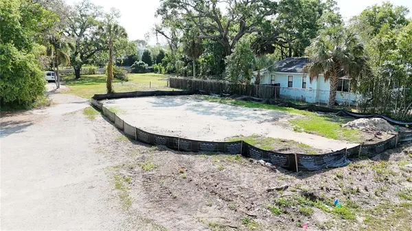 a view of a wooden house with swimming pool and wooden fence