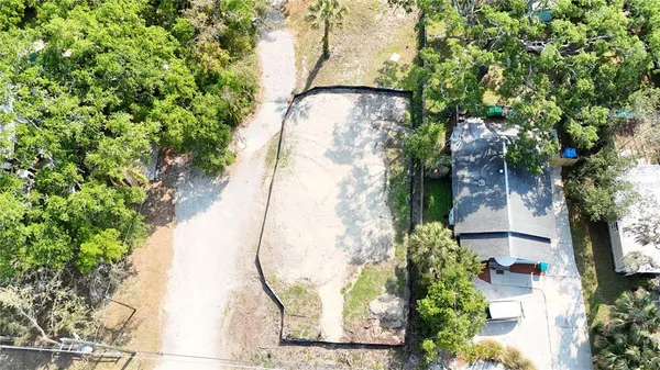 a view of a backyard with table and chairs