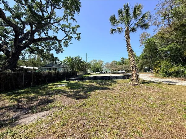 a view of a backyard with wooden fence
