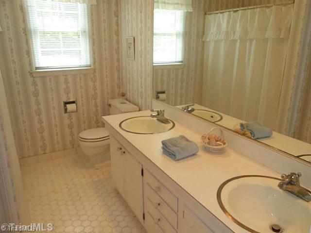 1170 Sweetbriar Road High Point, NC 27262 - Photo 11 of 16 Bath. The hall bathroom has white tile and a double vanity. There are 3 linen closets to store all your towels and sheets.