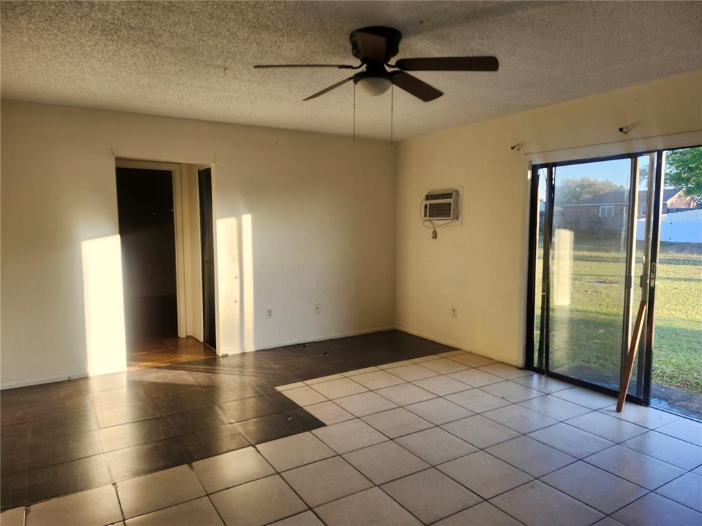46 Palm Road Ocala, FL 34472 - Photo 3 of 7 an empty room with wooden floor and a chandelier fan