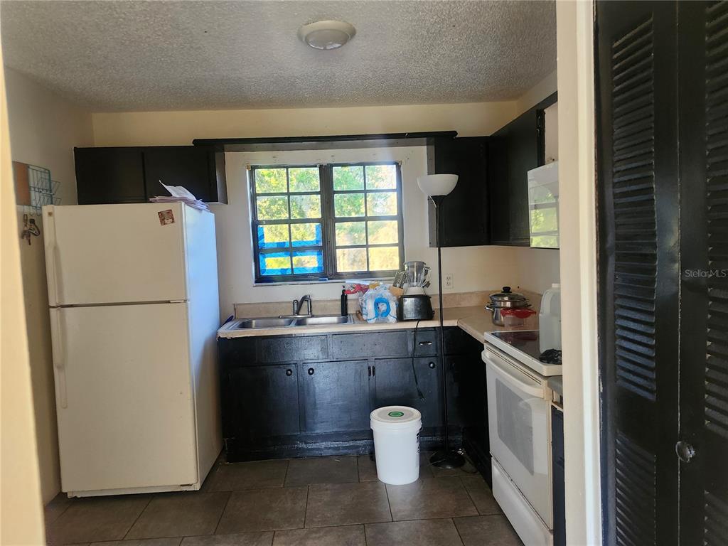 46 Palm Road Ocala, FL 34472 - Photo 4 of 7 a kitchen with a refrigerator and a sink