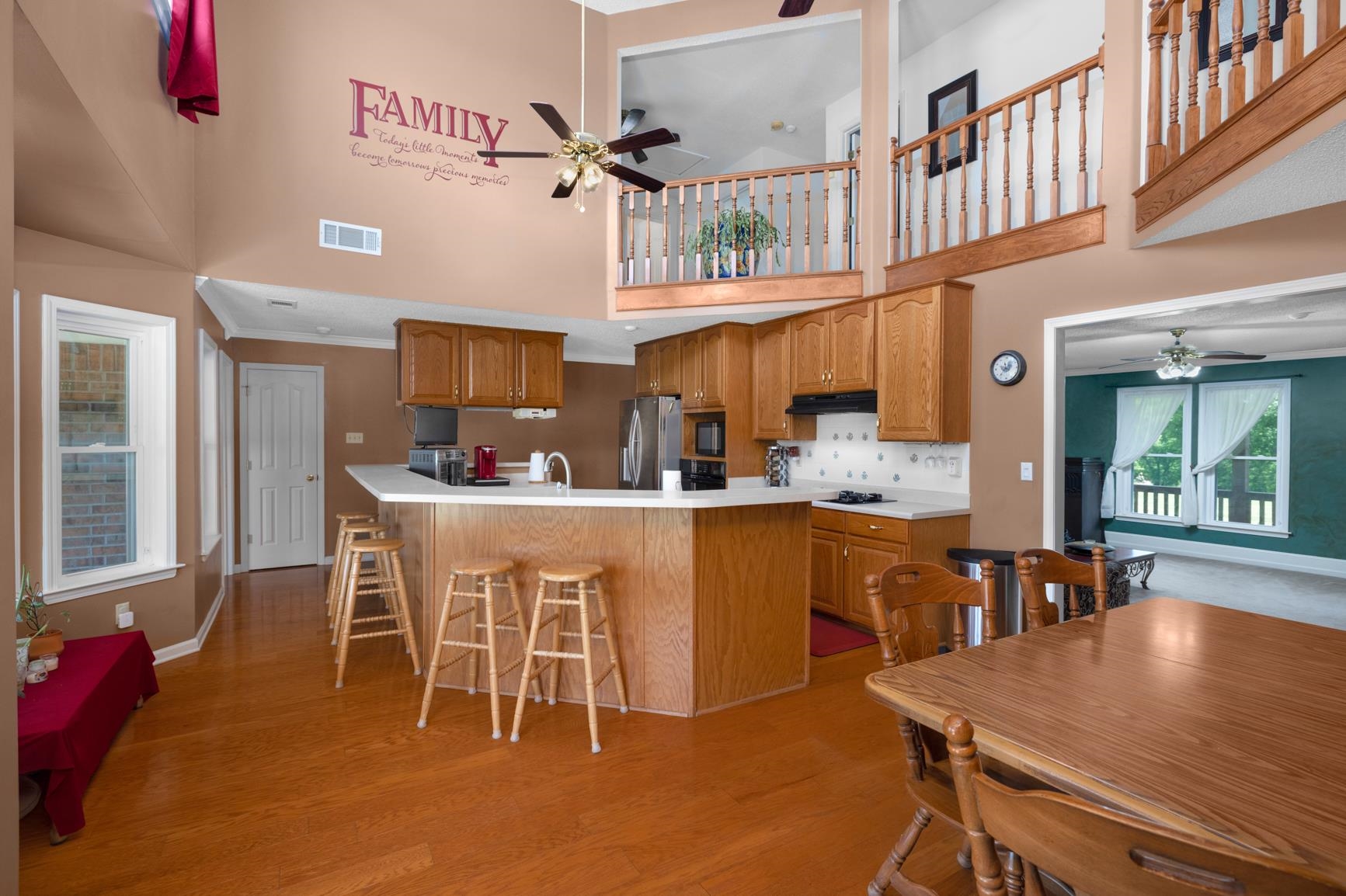 8539 Campground Road Drummonds, TN 38023 - Photo 11 of 38 a dining room with stainless steel appliances kitchen island granite countertop a table chairs and a refrigerator