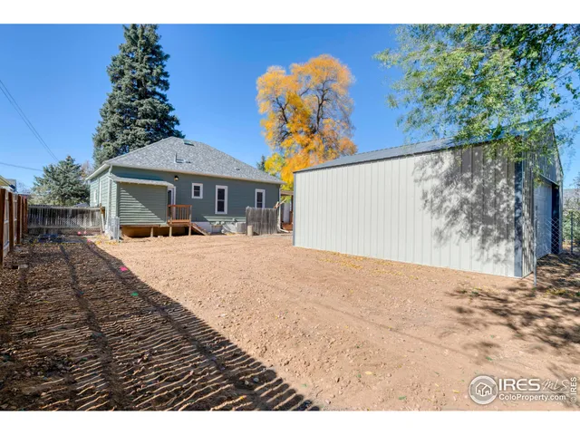 a view of a white house with a yard