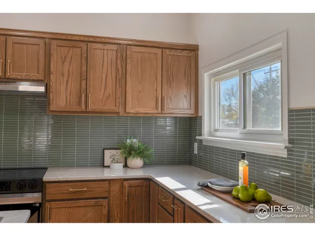 a kitchen with a sink cabinets and window