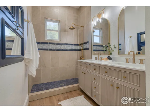 a bathroom with a sink a mirror and a shower