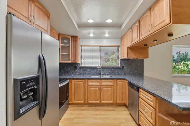 a kitchen with a sink a counter top space and living room