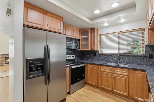 a view of kitchen and hall with wooden floor