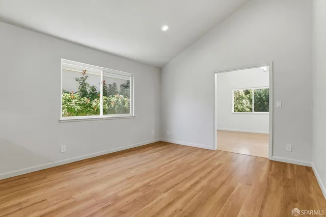 a bedroom with a bed and painting on the wall