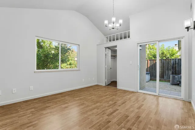 a view of empty room with wooden floor