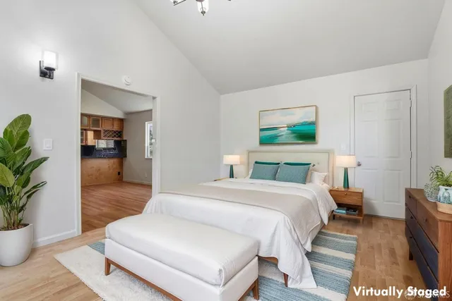 a bedroom with a bed and a painting on the wall