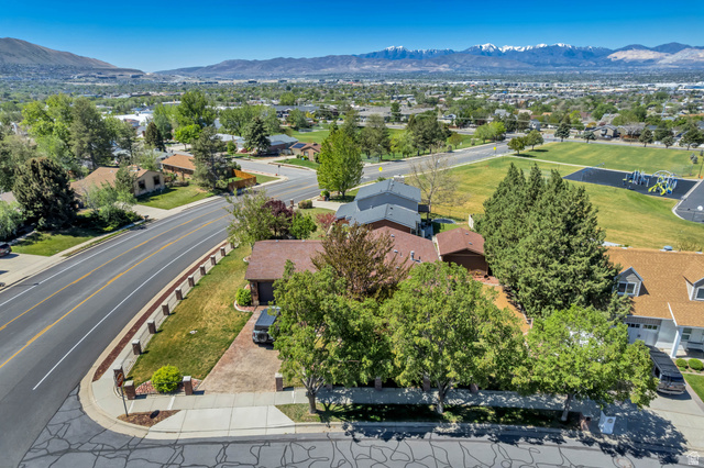 12080 Mill Ridge Circle Sandy, UT 84094 - Photo 53 of 56 Aerial perspective showcasing a residential area with a paved street