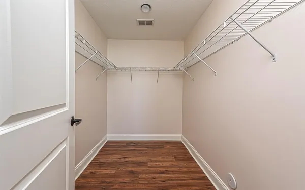 a view of a room with wooden floor and white walls