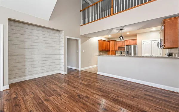 a view of a hallway with wooden floor