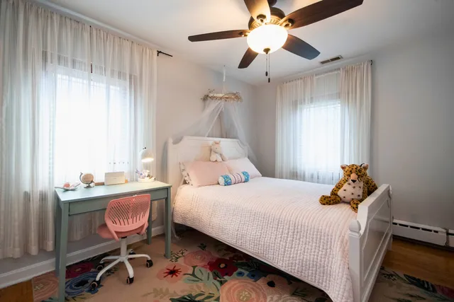 a bedroom with a bed and a chair