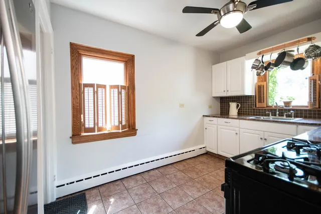 a kitchen with a stove a sink and a window