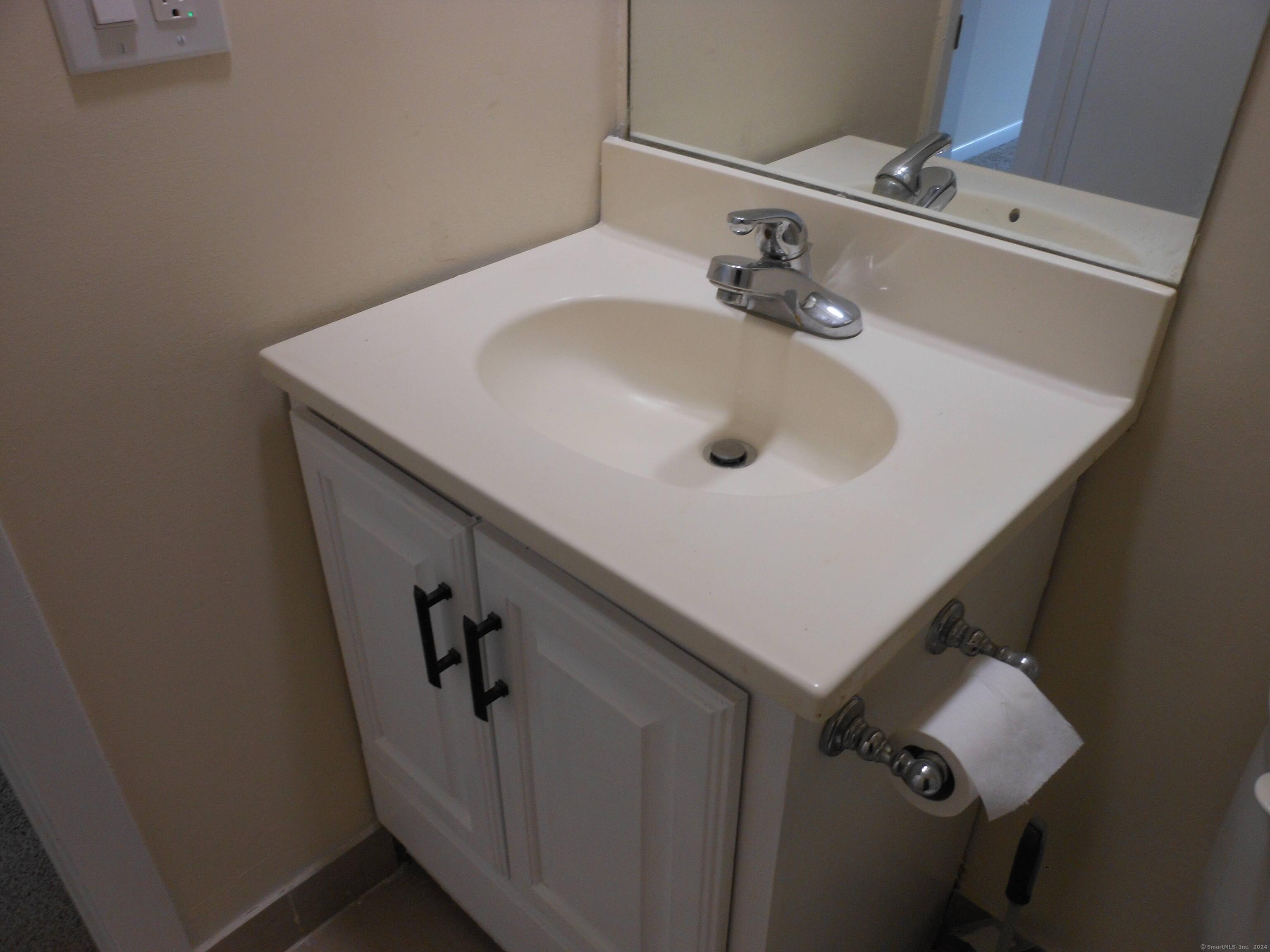 155 Short Beach Road, Unit 206 Stratford, CT 06615 - Photo 22 of 31 a bathroom with a sink and mirror