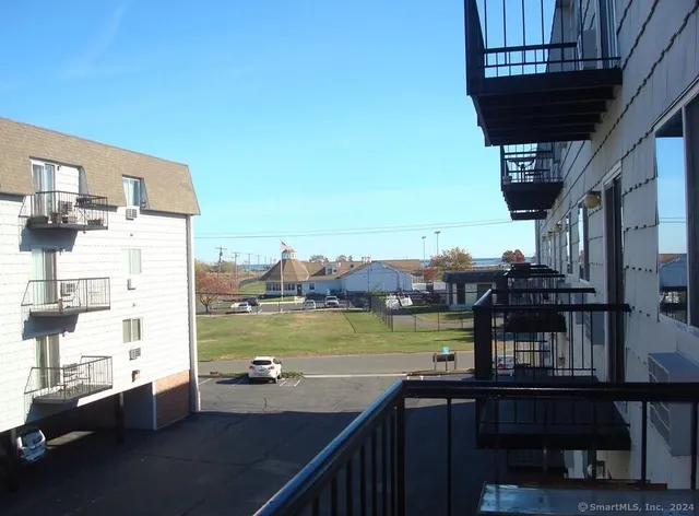 a view of a lake with couches in a patio