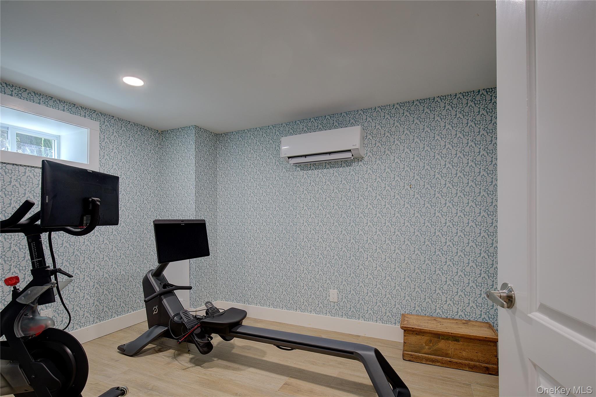 2 Spring Hollow Road Centerport, NY 11721 - Photo 31 of 44 Workout area featuring light wood-style flooring, recessed lighting, an AC wall unit, and wallpapered walls