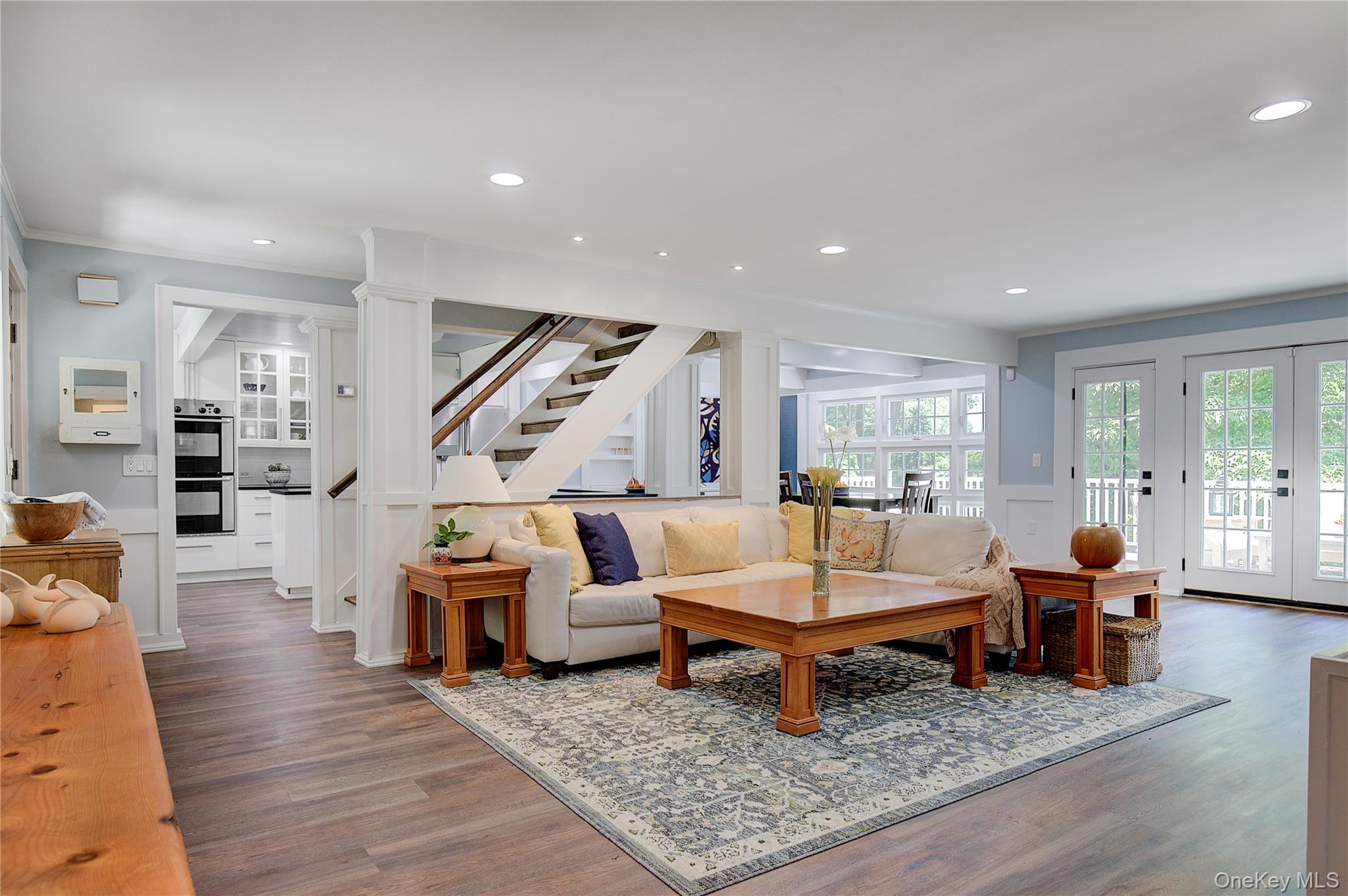 2 Spring Hollow Road Centerport, NY 11721 - Photo 4 of 44 Living area featuring recessed lighting, wood finished floors, french doors, stairs, and a wainscoted wall