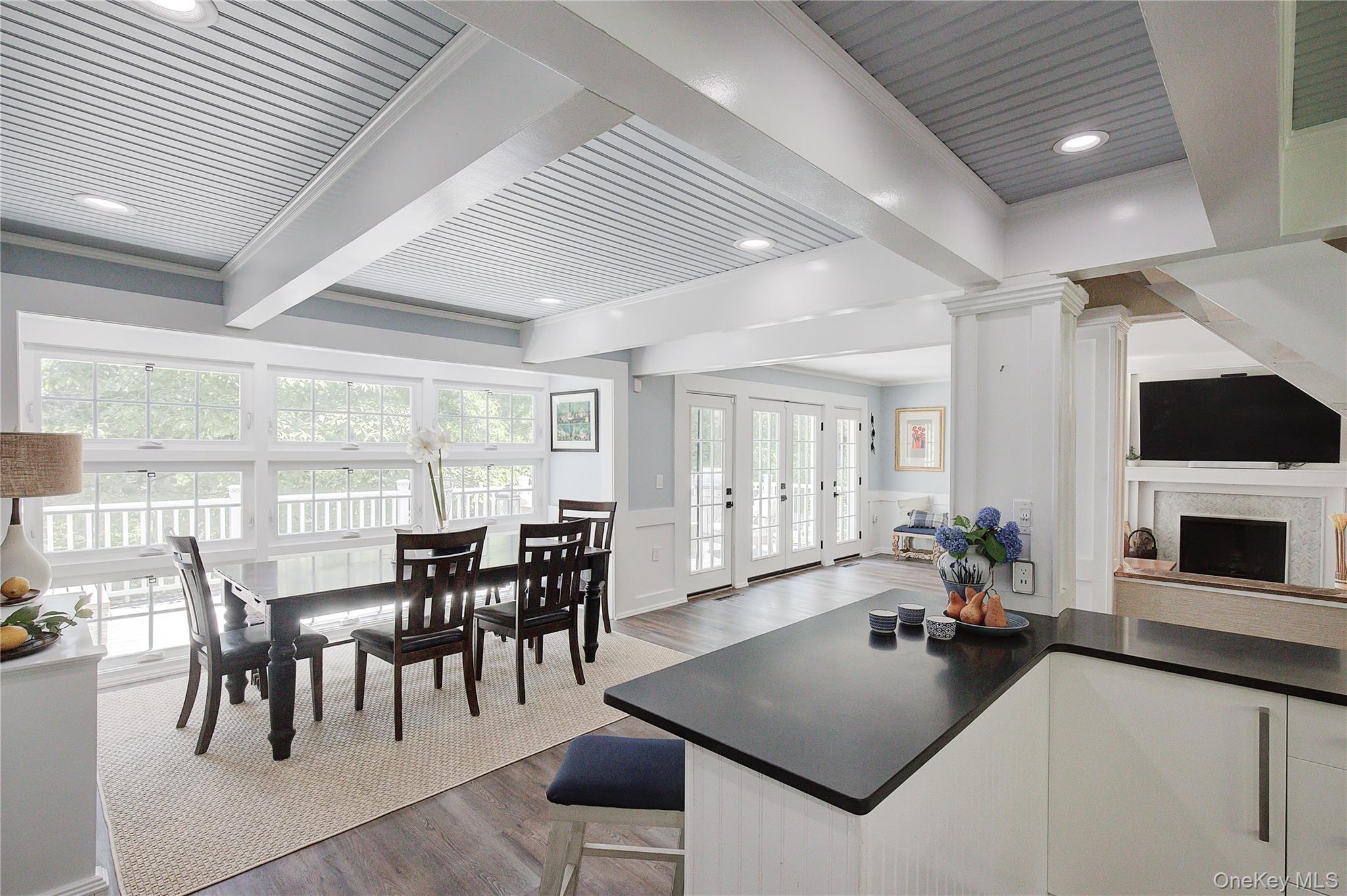 2 Spring Hollow Road Centerport, NY 11721 - Photo 10 of 44 Kitchen featuring beamed ceiling, dark wood-type flooring, wainscoting, french doors, and white cabinetry