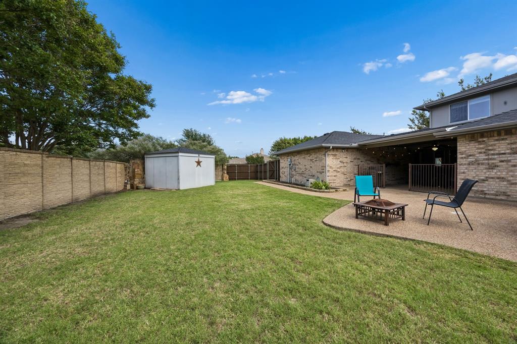 545 Rothschild Lane Murphy, TX 75094 - Photo 25 of 27 Expansive backyard with large storage unit situated on concrete slab.