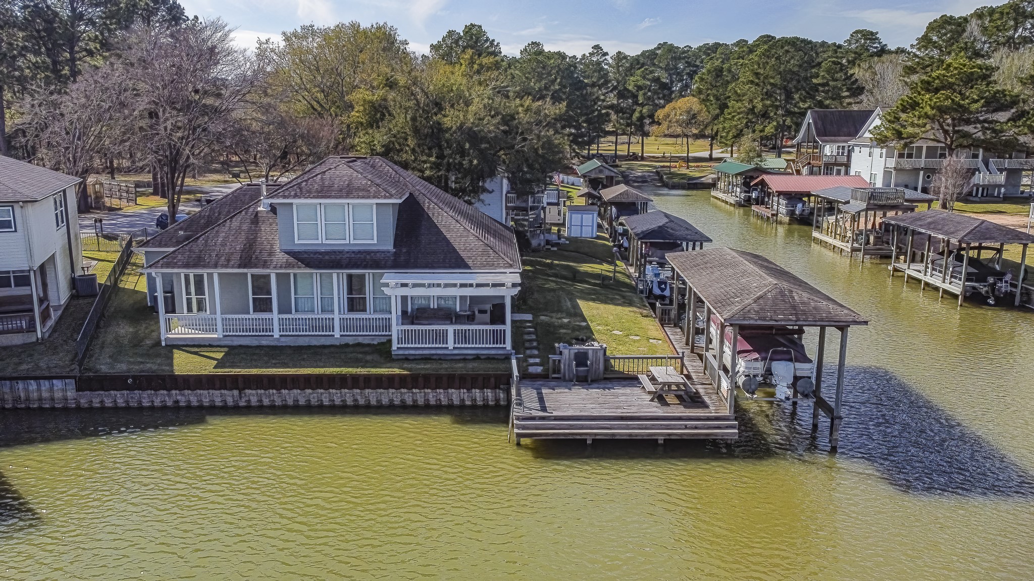 Private waterfront home with covered boathouse and dock, perfectly positioned along a quiet Lake Livingston channel.