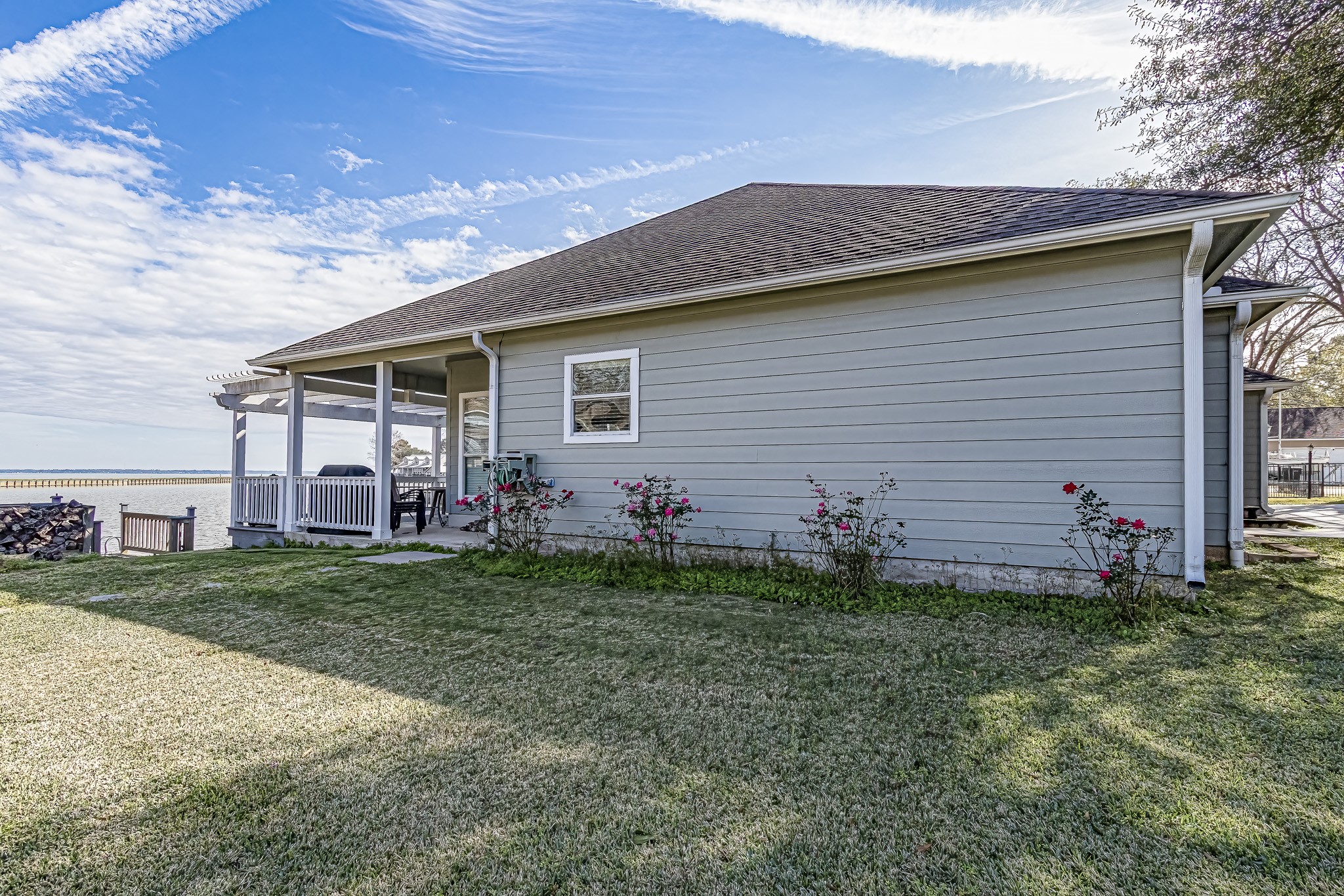 27 Marina Court Coldspring, TX 77331 - Photo 12 of 38 Manicured lakeside yard with easy access to covered patio and water.