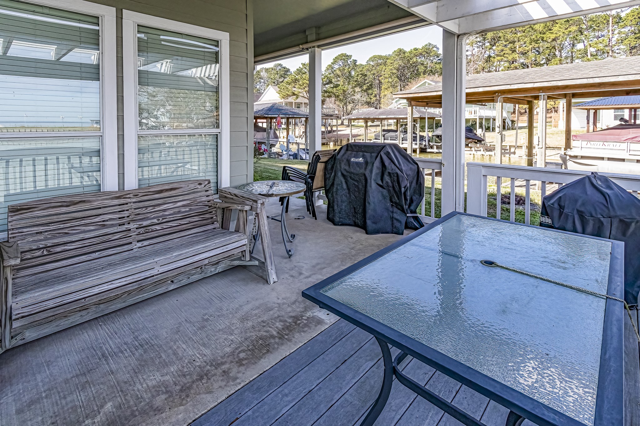 27 Marina Court Coldspring, TX 77331 - Photo 18 of 38 Covered patio ideal for entertaining with tranquil lake views.