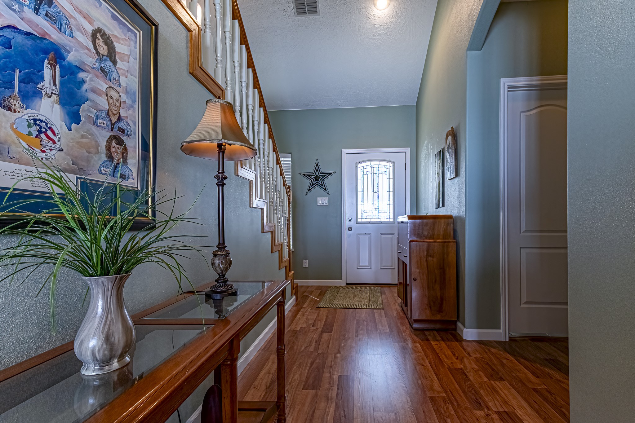 27 Marina Court Coldspring, TX 77331 - Photo 20 of 38 Inviting entryway with warm wood flooring and elegant staircase detail.