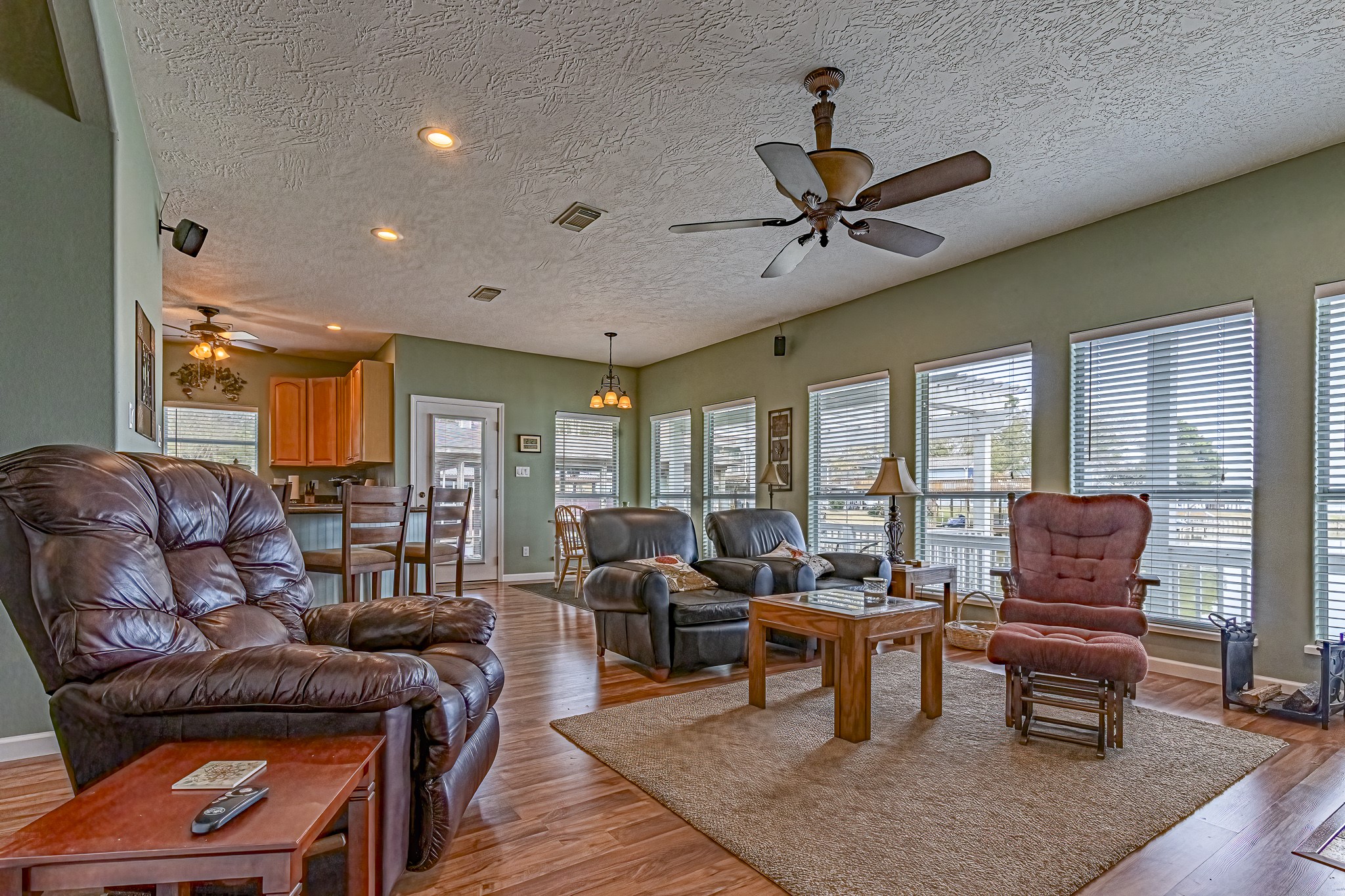 27 Marina Court Coldspring, TX 77331 - Photo 22 of 38 Inviting lake-view living space featuring a stone-accent fireplace and abundant natural light.