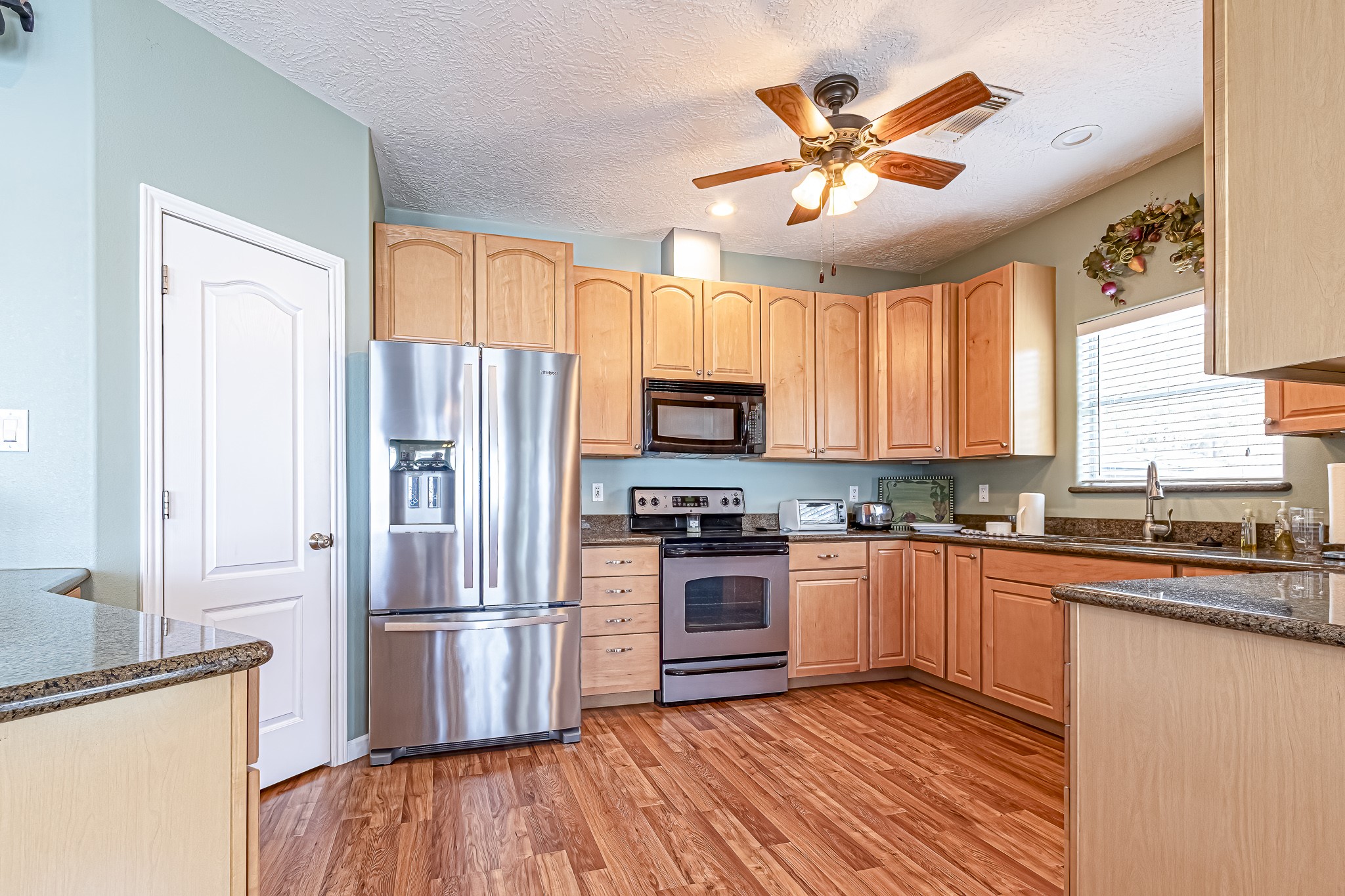 27 Marina Court Coldspring, TX 77331 - Photo 23 of 38 Bright, open kitchen featuring stainless steel appliances and ample cabinetry.