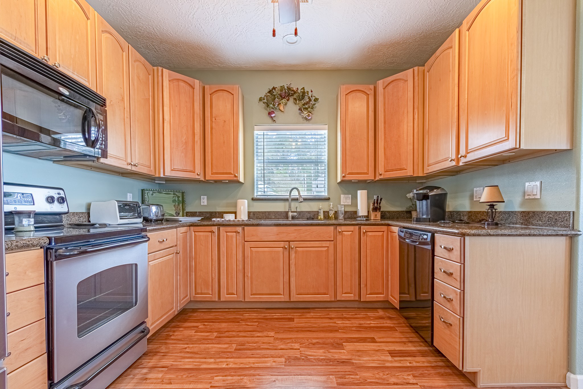 27 Marina Court Coldspring, TX 77331 - Photo 25 of 38 Inviting kitchen offering granite countertops, stainless appliances, and abundant cabinet space.